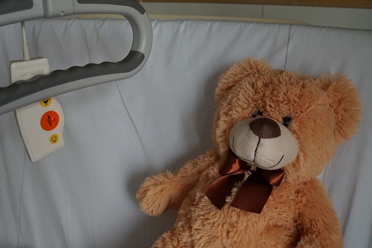 hospital bed with teddy bear