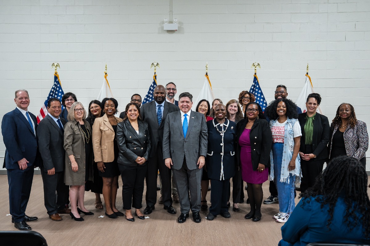 State Senators Graciela Guzman, Celina Villanueva, Elgie Sims Jr., Lakesia Collins and Mattie Hunter stand with Governor JB Pritzker and other elected officials