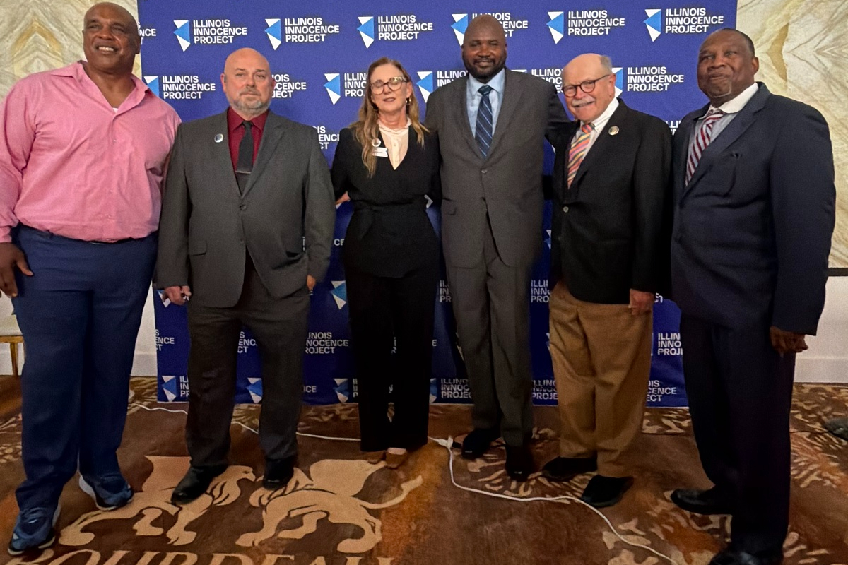 State Senator Elgie R. Sims, Jr. poses with exonerated Illinoisans and Illinois Innocence Project leaders at a press conference celebrating the signing of House Bill 3663