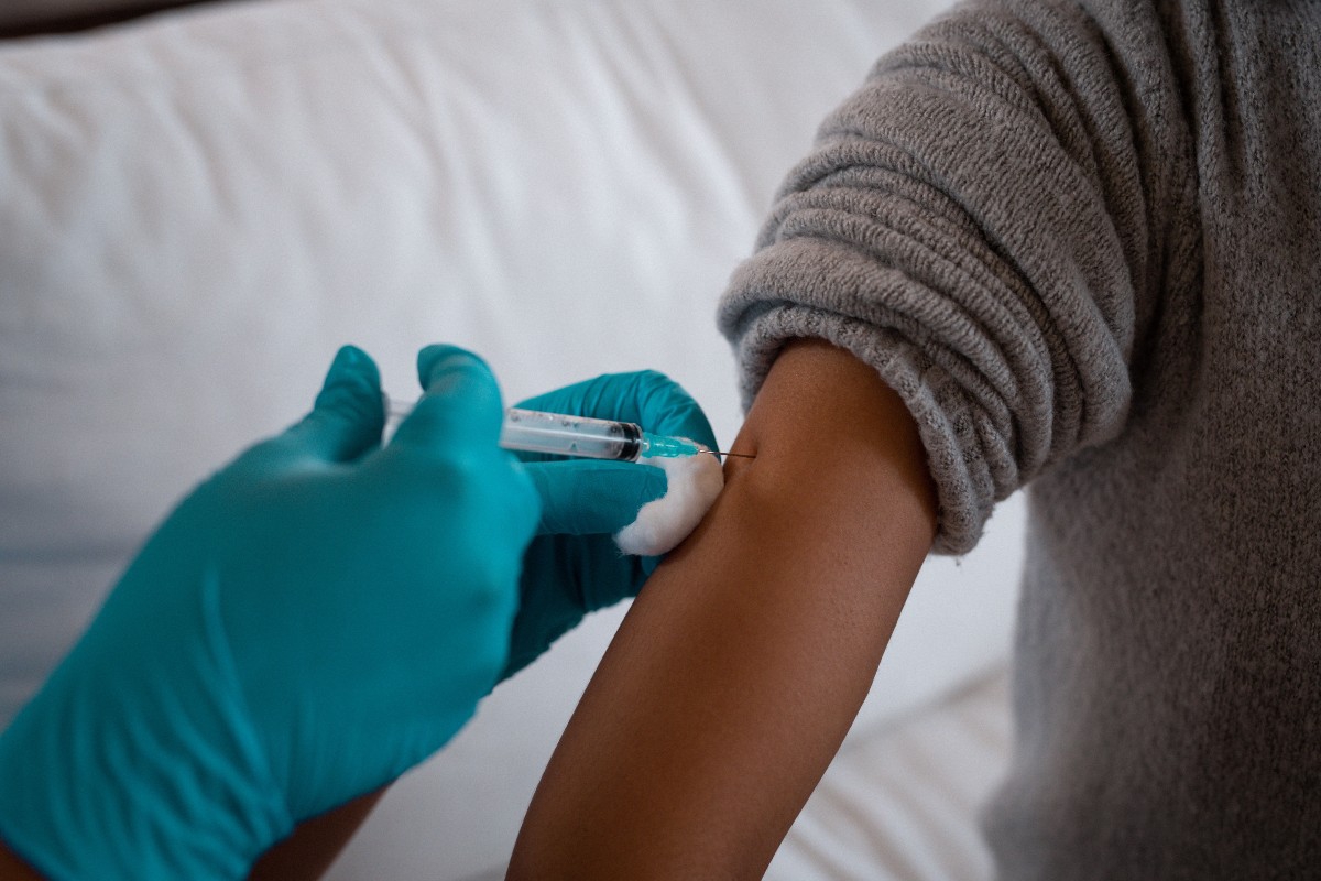 hands of doctor giving patient a shot